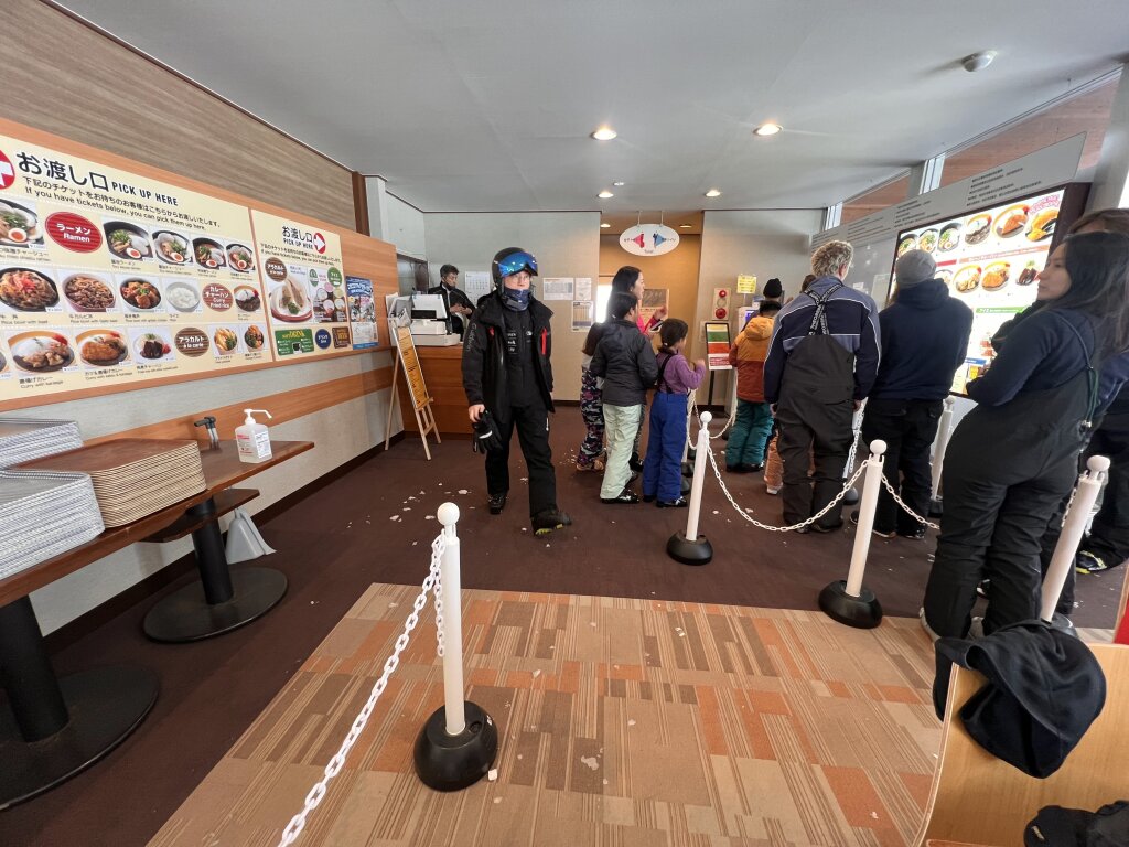 This is the lower budget way to eat lunch at Niseko.  Order and pay at the machine and pick up your food at the counter.  Standing room only in the small lodge.  February 2025