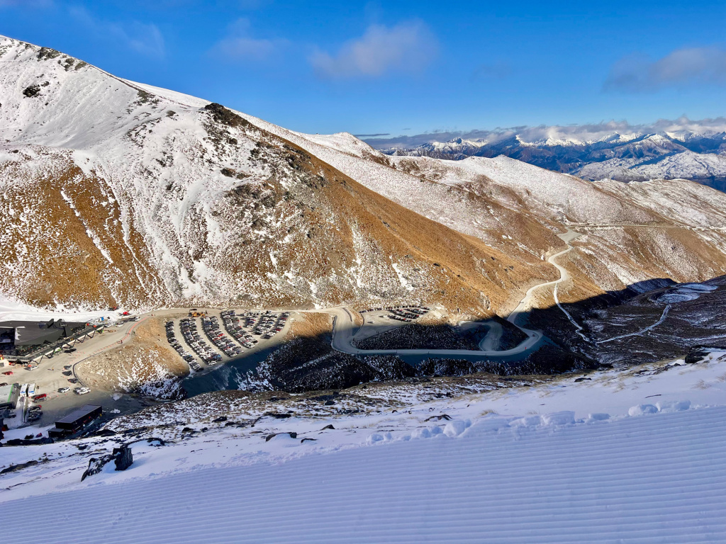 Parking lots at The Remarkables New Zealand, August 2025.  Note the terrain above them includes several named runs and you can ski down to the lower parking lot and shuttle back up if there is snow.
