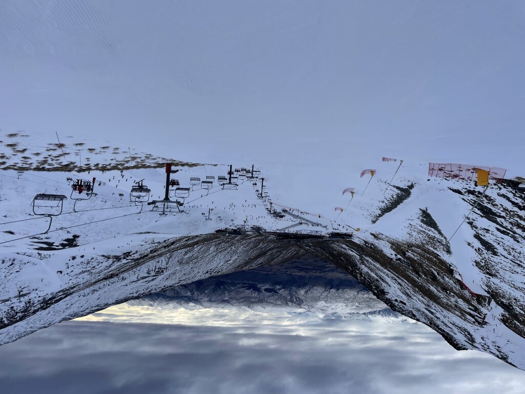 View from the top of the Alta chair at The Remarkables New Zealand, August 2025.  This run is steeper, but there is easy access to green runs on skier's right.  "Calypso" on the left is the road down from the bottom of Shadow Basin when there isn't enough snow to ski the steep part all the way down to the chair.